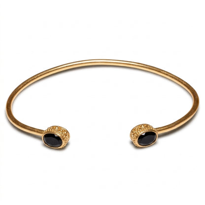 A gold open cuff bangle bracelet with oval black onyx stones set in textured gold bezels for women at RM Kandy